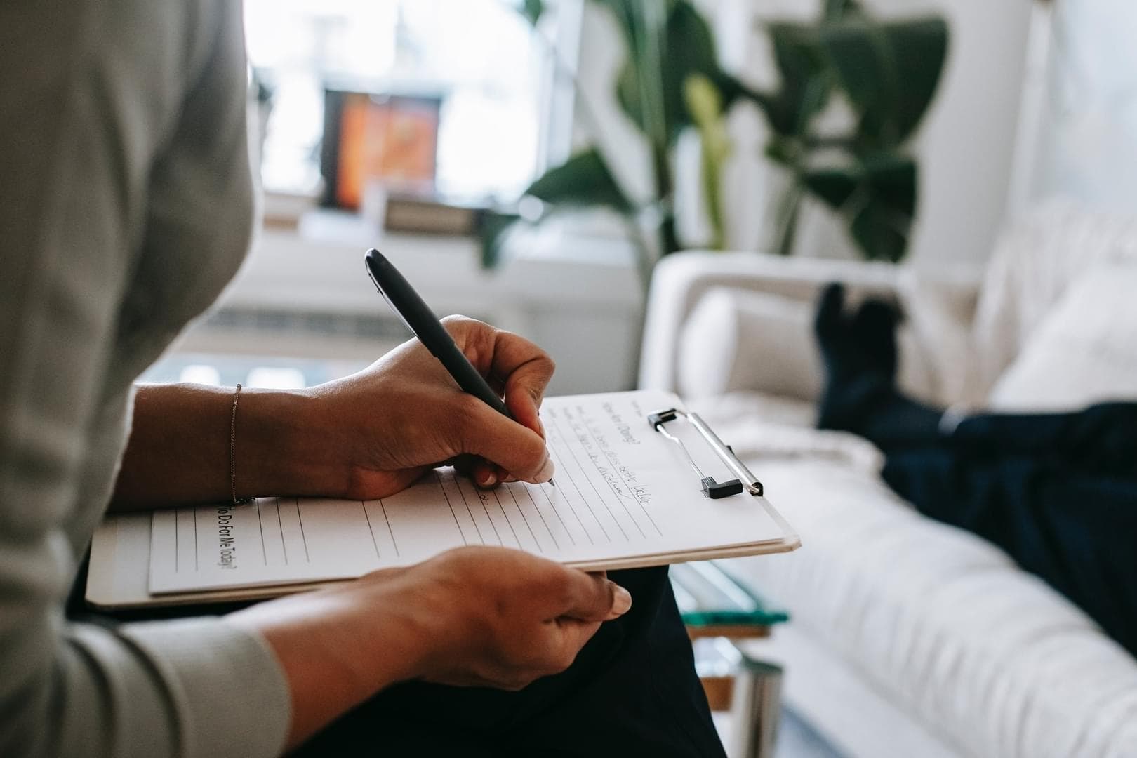 A therapist taking notes during a session